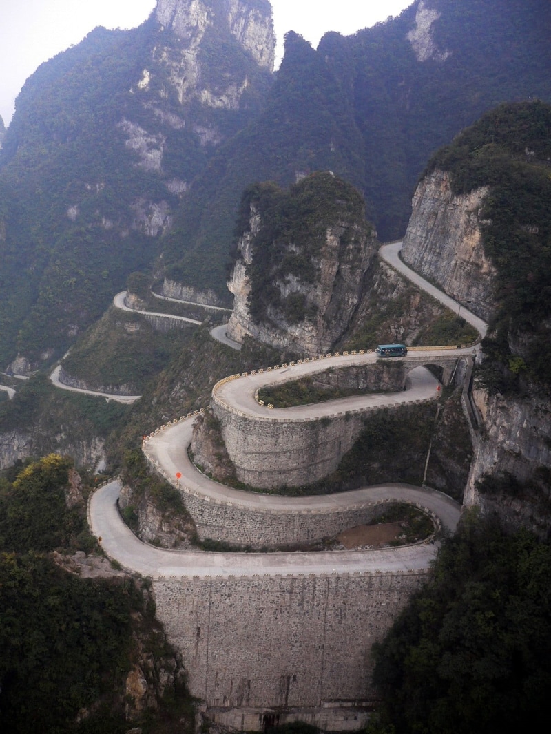 day, transportation, high angle view, hairpin turns, outdoors, mountain road, travel, tranquility, travel destinations, mountains, mountain range, road