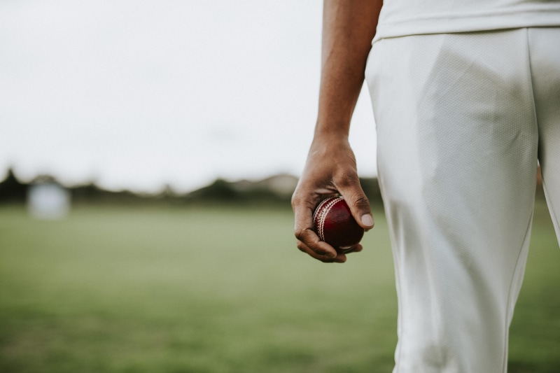 athlete, young adult, leather ball, sportsman, colors, one person, blurred, focus on foreground, outdoors, human body part, playing, red, green, men, leather