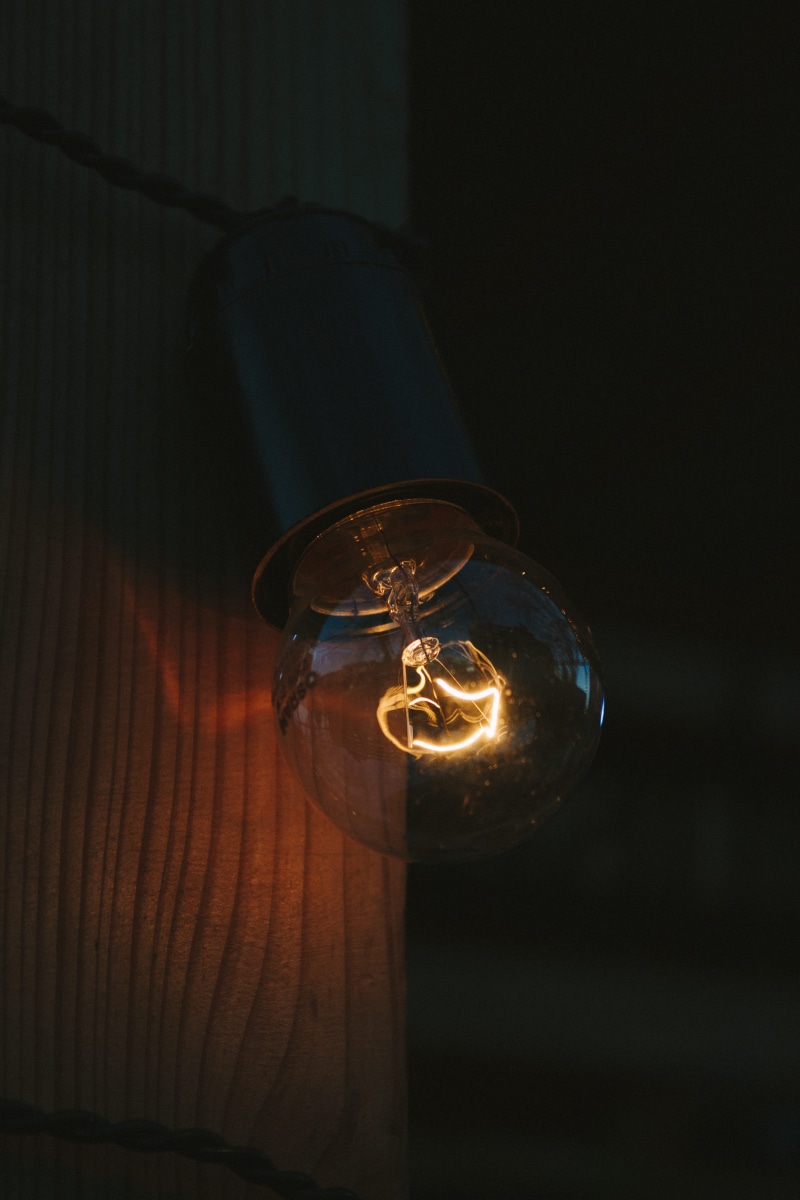 darkroom, bulb, clear, close-up, 5K, table, energy, night, music, art, lamp, light bulb, filament, single object, black background, still life, spotlight