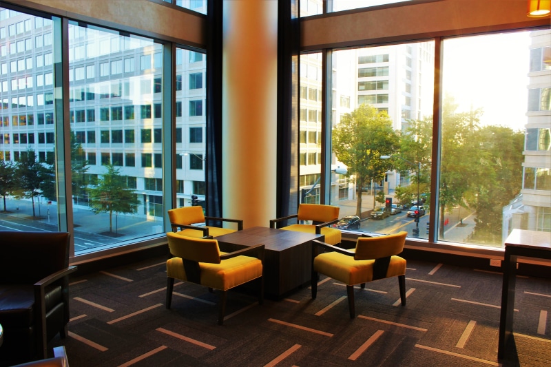 flooring, furniture, table, living room, seat, sofa, city, four, building, modern, skyscraper, chairs, nature, surrounded, brown, glass - material, office building exterior
