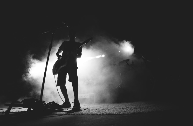 one person, guitarist, adults only, occupation, stage, entertainment occupation, silhouette, one man only, guitar, black and white, illuminated, playing