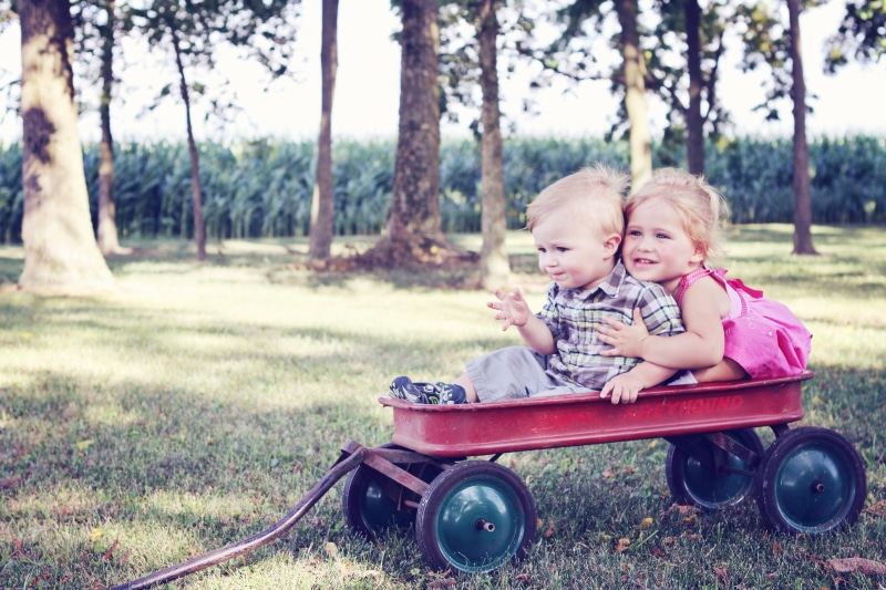 grass, joy, child, females, caring, children, together, smiling, innocence, leisure activity, family, real people, friends, outside, two people, lifestyles