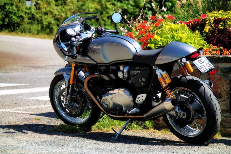outdoors, parallel-twin, parking, no people, travel, motorcycle, city, tree, sunlight, shadow, day, street, road, plant, 1080P, stationary, nature, british