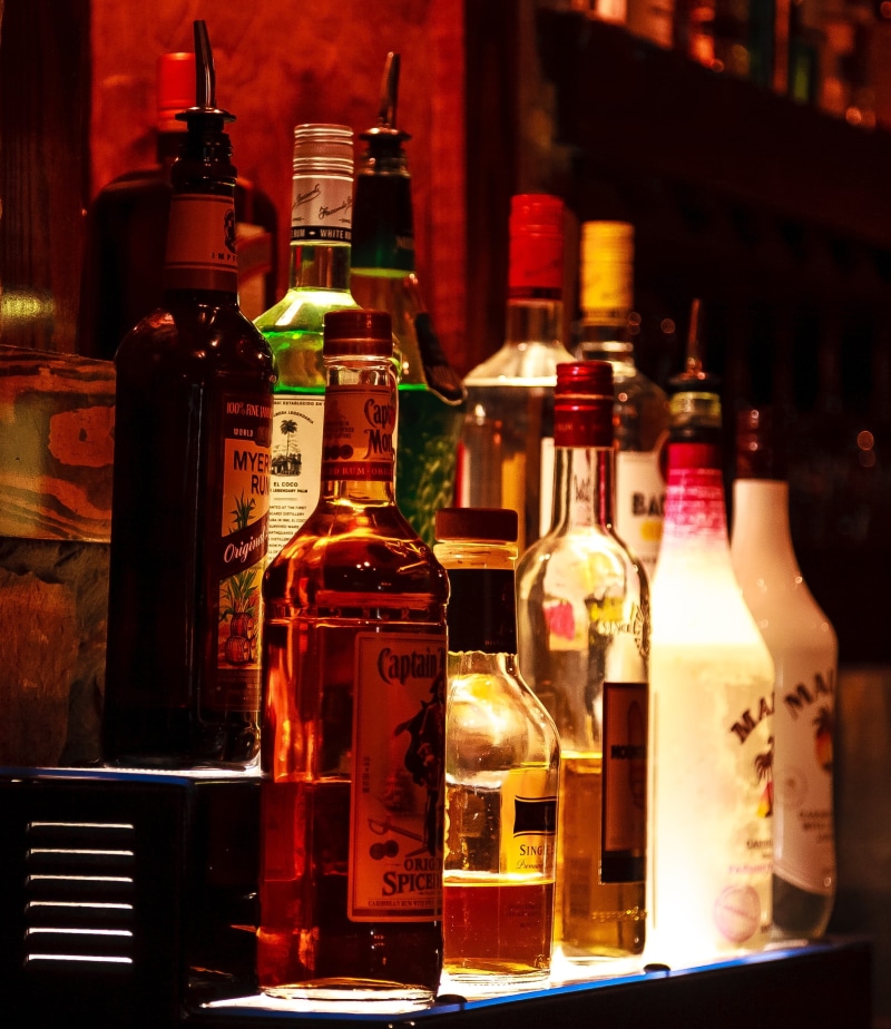glass, bottles, shelf, text, cocktail, choice, close-up, bar, scotch, no people, food and drink, hard liquor, glass - material, variation, nightclub, club