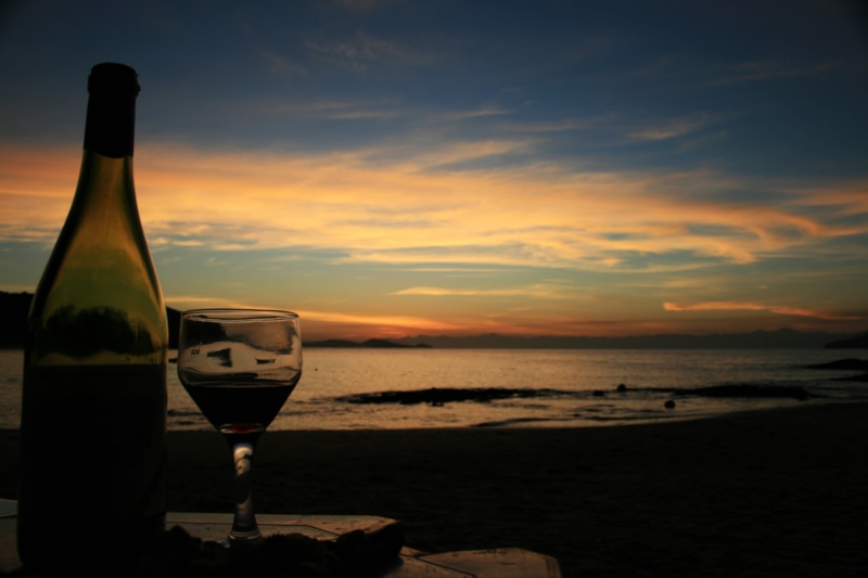 land, refreshment, drink, bottles, beauty in nature, food and drink, beach, bottle, glass - material, glass, water, alcohol, red wine, sunset, sea, cloud - sky
