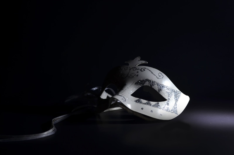 venetian mask, single object, table, close-up, eye mask, mask - disguise, black background, masquerade, closeup, copy space, white color, dark, still life