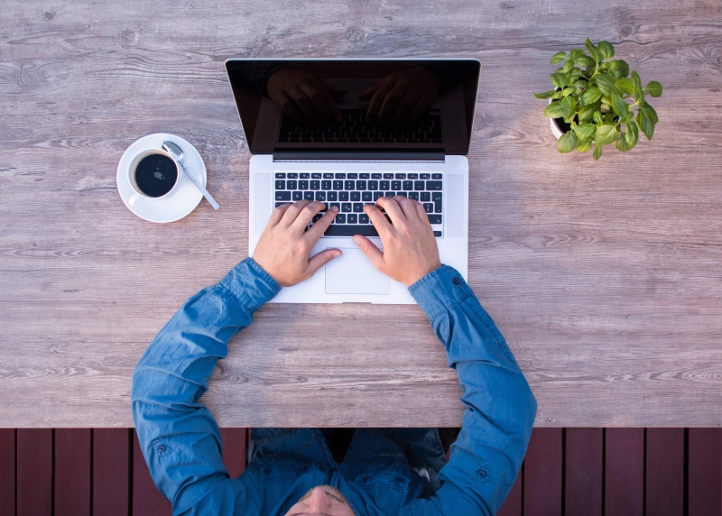 directly above, a middle-aged woman, person, food and drink, one person, macbook, desk, communication, wireless technology, defect, cup, s, work, simply