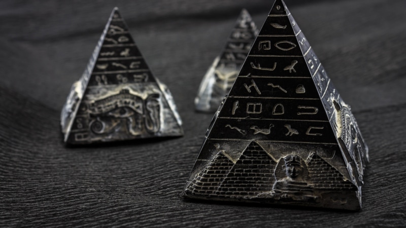 triangle shape, shape, pyramid shape, wooden, representation, indoors, white, black, high angle view, table, hieroglyphs, no people, star shape, focus on foreground