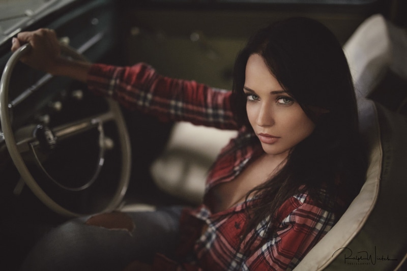 car, focus on foreground, sitting, plaid, women, transportation, mode of transportation, checked pattern, adult, torn jeans, lifestyles, pants, beautiful woman
