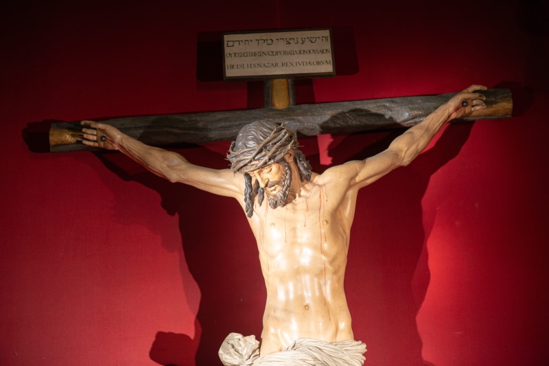 catholic, faith, seville, figure, holy, obscured face, christianity, church, arms raised, religion, indoors, colored background, symbol, crucifix, human representation