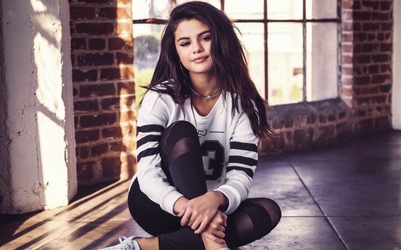 focus on foreground, one person, casual clothing, Selena Gomez, portrait, hair, lifestyles, architecture, sitting, day, women, three quarter length, young adult