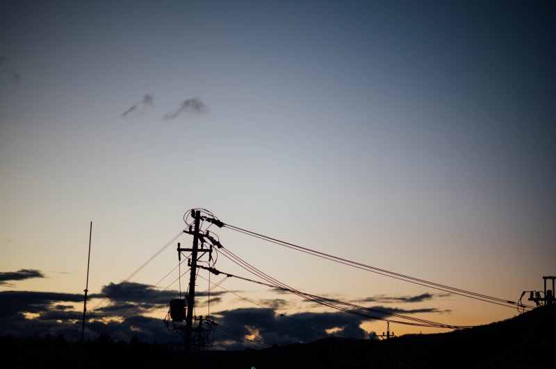 transportation, housing, dusk, beauty in nature, animal, sunset, tower, sunlight, power line, electricity pylon, low angle view, house, silhouette, fuel and power generation