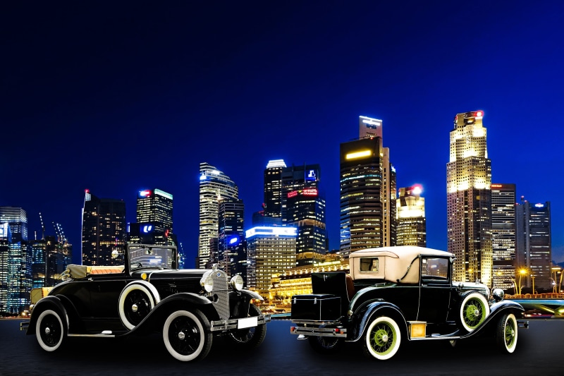two, coupes, blue, old, cityscape, building Exterior, buildings, no People, vehicle, traffic, old car, composing, sky, travel, downtown District, oldtimer