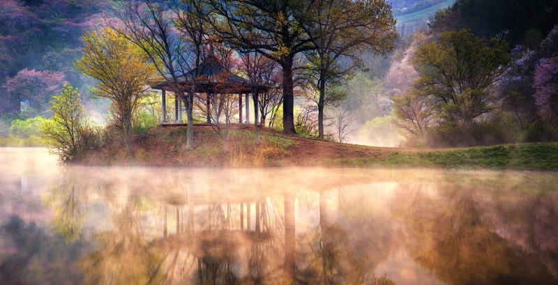 sky, outdoors, autumn, grass, sunbeam, mist, lake, tranquil scene, tree, land, South Korea, trees, beauty in nature, mountains, plant, environment, landscape