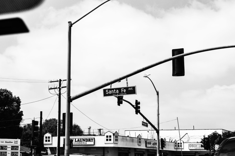 fe, intersection, sky, vehicle, car mirror, light, food, communication, santa, street, compton ca., day, meal, car, utility pole, bus stop, united states