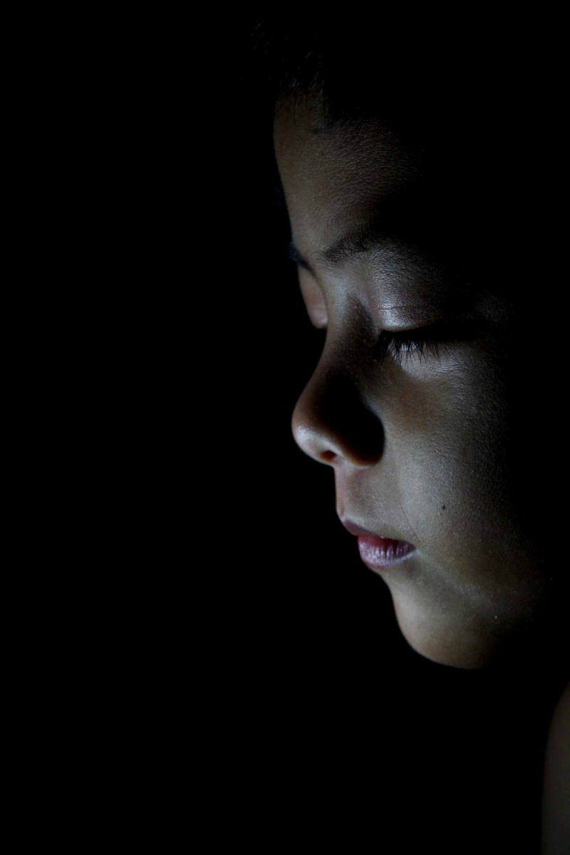 lifestyles, boy, close-up, people, body part, human body part, kid, child, young adult, dark, human face, indoors, 2K, one person, looking away, headshot
