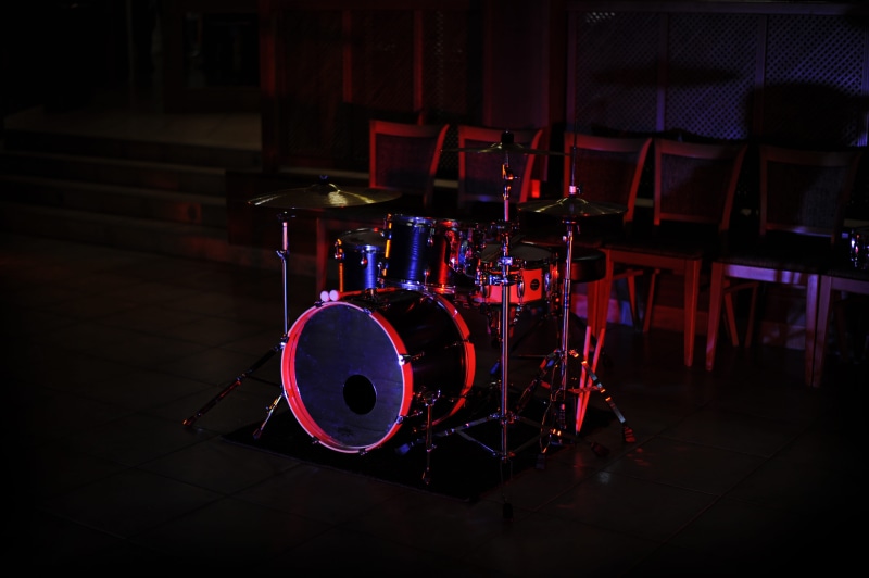 no people, lighting, illuminated, drummer, musician, pub, absence, rock music, purple, still life, music band, black, light, arts culture and entertainment