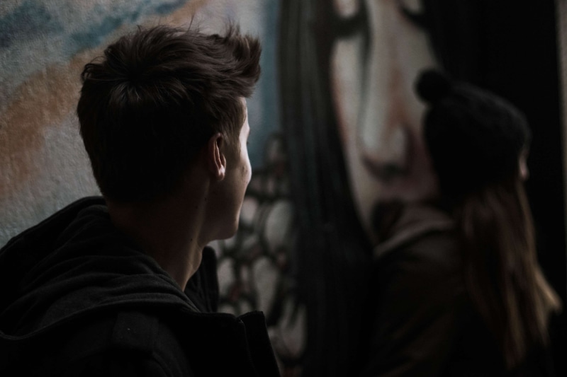 blur, casual clothing, contemplation, young, close up, adult, focus, girl, woman, brown hair, city, 4K, photoshoot, dark, sad, man, light, focus on foreground