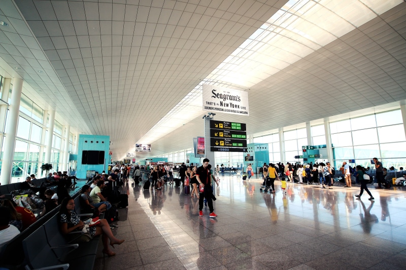 architecture, airport, crowd, public transportation, women, indoors, station, transportation, sign, airport check-in counter, large group of people, leaving