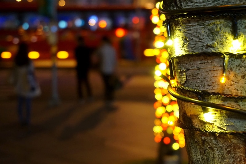 electric lamp, outdoors, lighting equipment, celebration, selective focus, night, city, yellow, light - natural phenomenon, beaded, spirituality, necklace