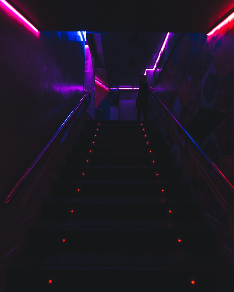 barcelona, architecture, party, railing, people, direction, dark, indoors, built structure, low angle view, transportation, pink, lighting equipment, blue