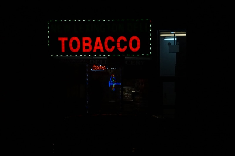 flare, indoors, communication, capital letter, monitor, commercial sign, tobacco, logo, red, signage, exit sign, laser, trademark, information, architecture
