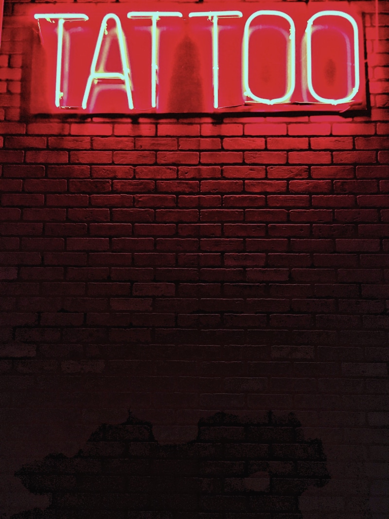 4K, wall, tattoo, lighted, illuminated, neon, red, signage, text, built structure, single word, information, low angle view, wall - building feature, brick wall