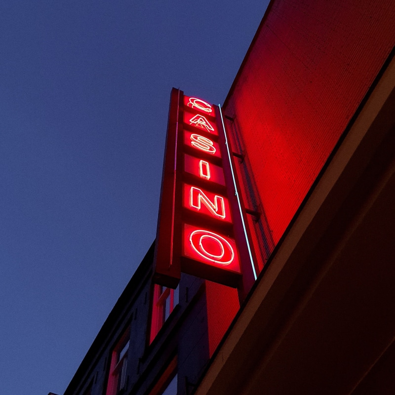 sign, city, building, sky, building exterior, red, hotel, redlight, sunset, casino, information, minimalist, corner, 2K, clear sky, trademark, illuminated