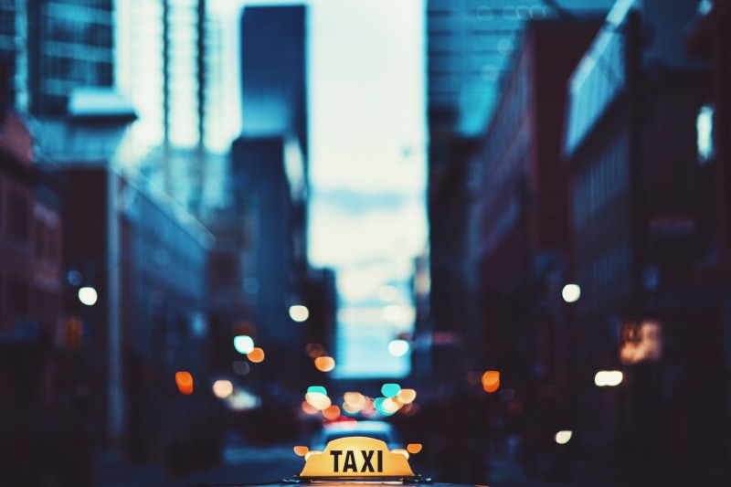 outdoors, road, taxi, mode of transportation, car, dusk, building exterior, 4K, focus, cityscape, light, urban, street, city life, selective, focus on foreground