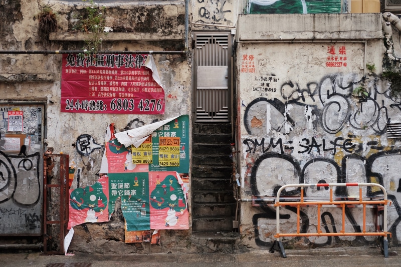 coat, wall, clothing, machine, wheel, built structure, walls, brochure, street art, creativity, art and craft, communication, outdoors, architecture, overcoat