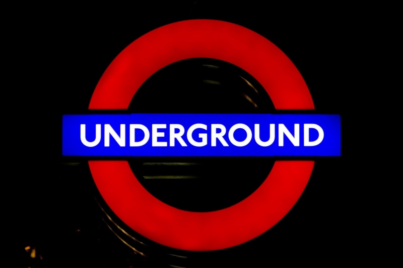 sign, illuminated, underground, england, studio shot, communication, train, signage, circle, red, technology, shape, black background, subway, metro, english