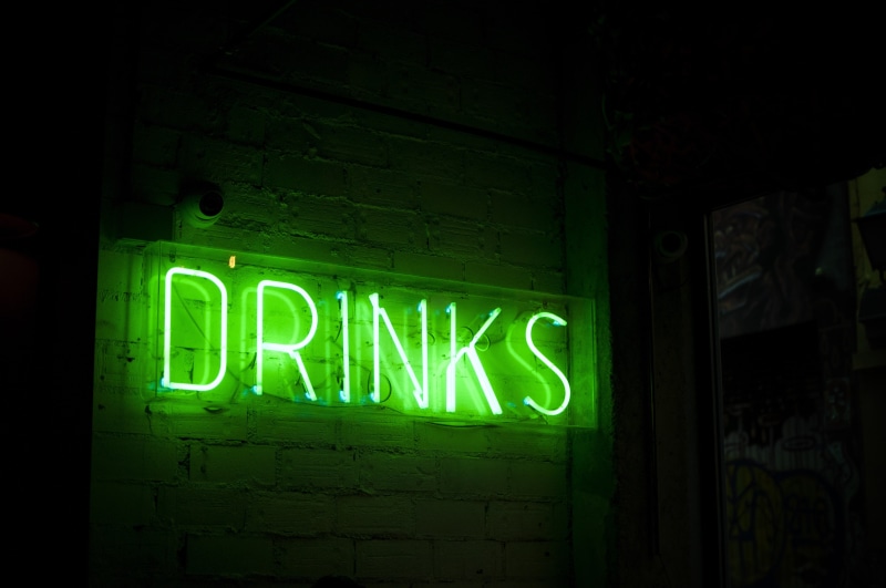 drinks, tube, no people, dark, green color, neon sign, the inscription, lamp, text, light - natural phenomenon, information, wall - building feature, illuminated