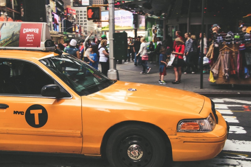 city street, waiting, yellow taxi, car, Times Square, people, incidental people, mode of transportation, real people, motor vehicle, architecture, group of people