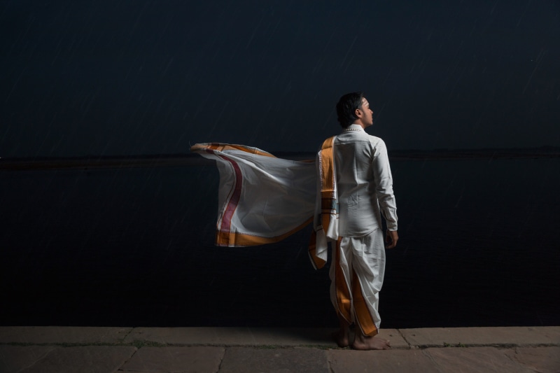 5K, black, standing, dark, clothing, black background, indian, person, facing, kurtum, one person, evening, saadhu, front, lifestyles, wall, varanasi