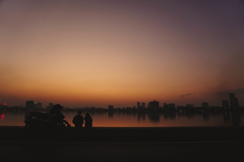 water, transportation, nightfall, chill, men, architecture, city, winter, mammal, west lake, outdoors, lake, vietnam, group of people, silhouette, nature
