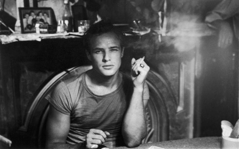 Marlon Brando, actor, waist up, men, portrait, sitting, 720P, front view, cigarette, real people, casual clothing, contemplation, one person, teenager