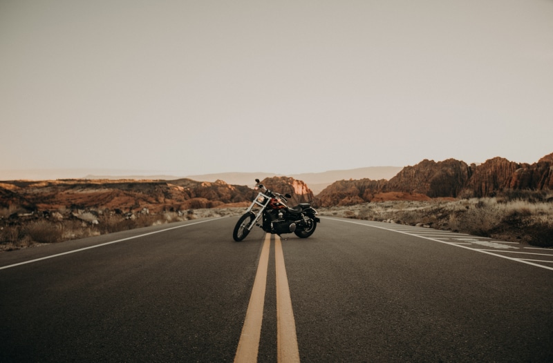 biker, the way forward, town, transportation, road, symbol, tarmac, machine, real people, highway, cruiser, one person, horizon, sky, ride, black, sign