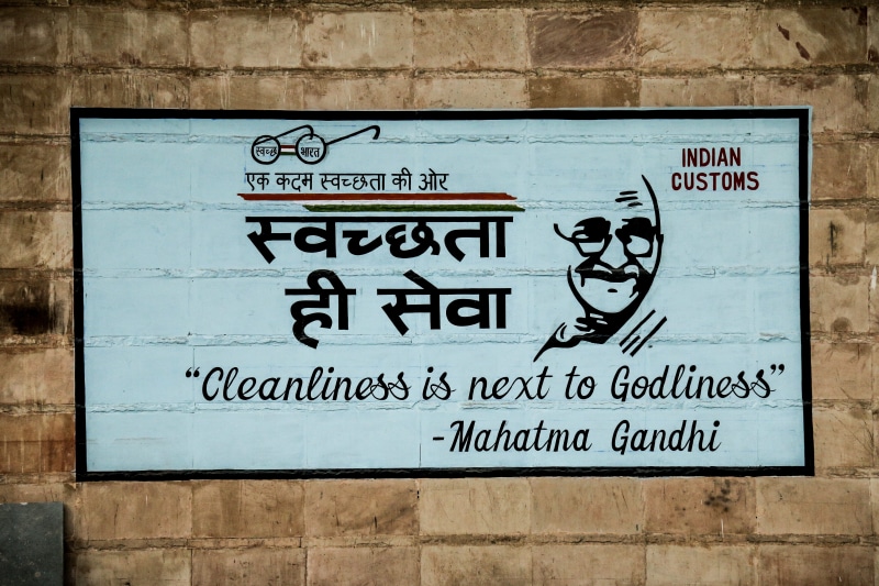 information sign, postal office, plaque, wall, symbol, creativity, appliance, human representation, wall - building feature, mahatma, calligraphy, brick
