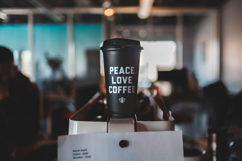 indoors, drink, food and drink, pub, text, hot drink, restaurant, person, table, cylinder, human, coffee, day, coffee shop, coffee cup, coffee - drink