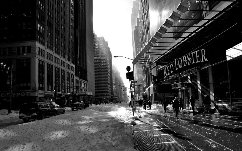 outdoors, land vehicle, office building exterior, road, New York City, architecture, red, street, snow, skyscraper, direction, cityscape, motor vehicle