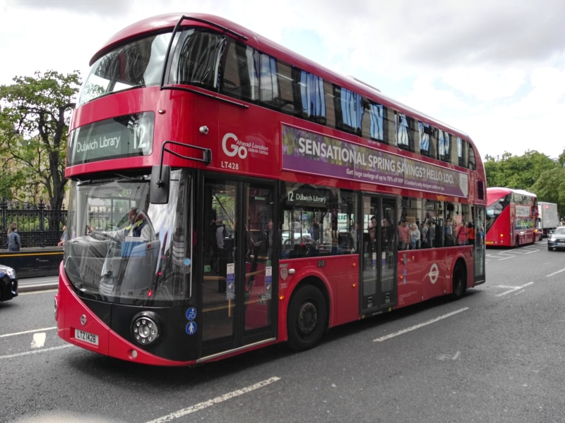 western script, england, double-decker bus, outdoors, public transportation, architecture, red, street, sky, mode of transportation, decker, text, sign