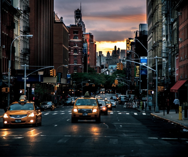 cabs, traffic, illuminated, cityscape, dawn, city street, building Exterior, mode of transportation, motion, sunset, urban Skyline, color Image, people