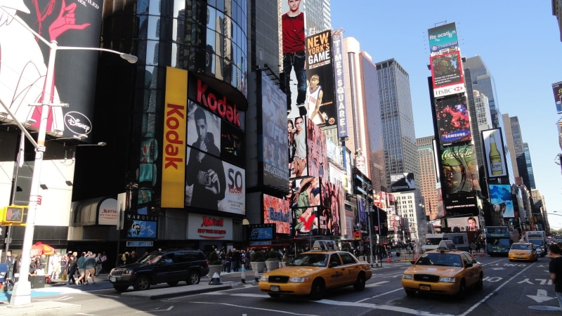 city, building exterior, architecture, road, motor vehicle, sign, yellow, city life, modern, skyscraper, crown, city street, two, near, street, outdoors