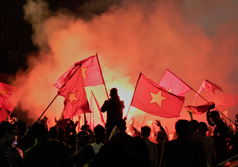 fire, holding, red, flags, human, smoke - physical structure, men, lifestyles, outdoors, night, vietnam, nature, rock concert, event, parade, festival