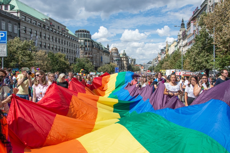 built structure, flag, building exterior, human, women, multi colored, architecture, nature, large group of people, sky, men, plant, cloud - sky, group of people