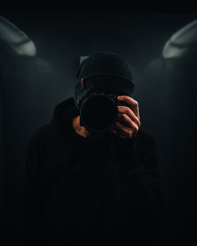 long sleeve, photography, hat, headshot, portrait, self, aggression, electronics, clothing, camera, social issues, sweater, one person, cold, obscured face