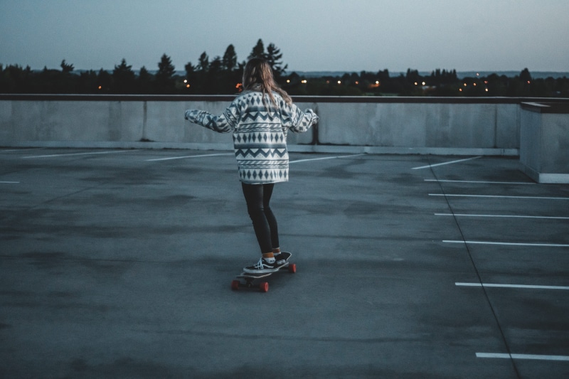 skateboarding, one person, city, architecture, hairstyle, transportation, full length, real people, rear view, road, lifestyles, skate, sport, clothing