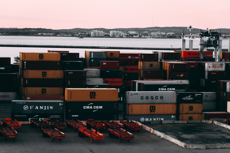 no people, sky, cargo ship, water, freight transportation, harbor, crate, containers, number, communication, forest, assorted, seaport, text, near, body