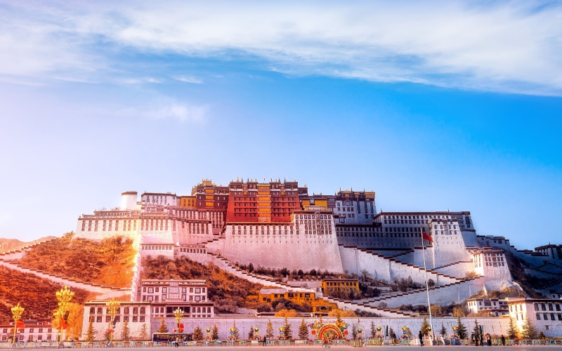 day, building exterior, potala, history, travel, architecture, tourism, tibet, city, building, blue, residential district, nature, no people, tree, sky