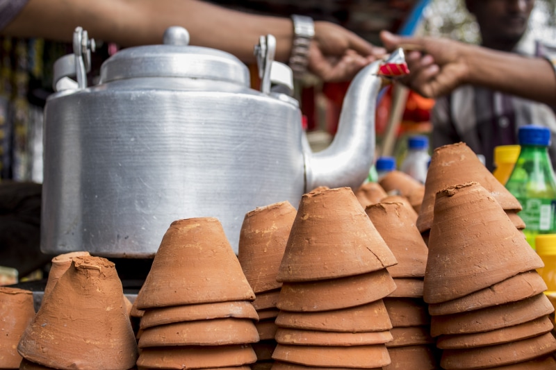 mud cup, traditional, focus on foreground, human body part, large group of objects, close-up, container, food and drink, business, retail, india, tea, 5K